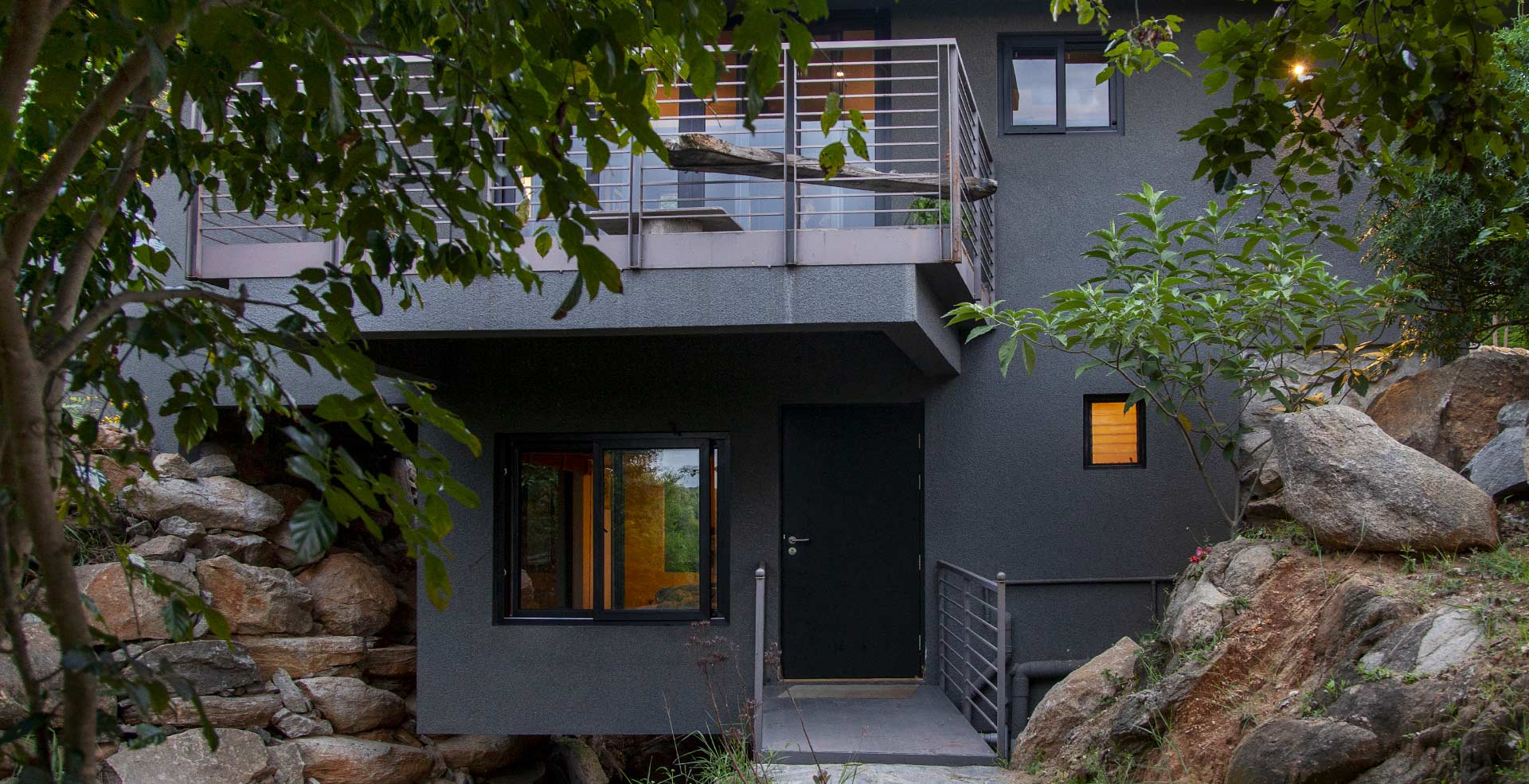 The Hideout cabin built among granite boulders and trees at Crossroads Getaway